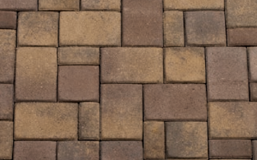 Close-up view of a 3-piece random standard paver pattern in territorial earth tones.