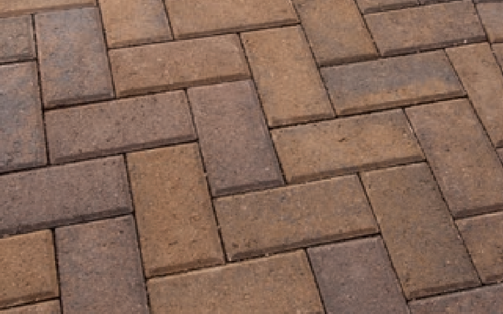 Close-up view of a herringbone paver pattern featuring native Holland pavers in warm earth tones.